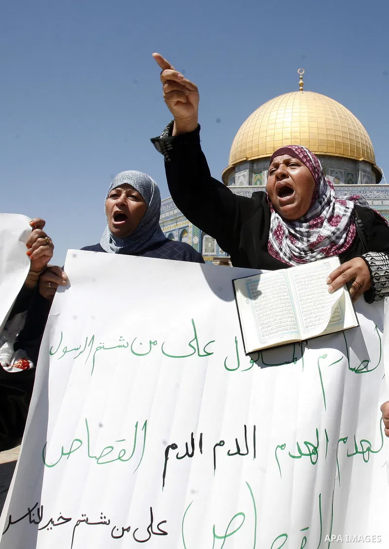 Palestinian women shout slogans during a demonstration against the controversial film 'Innocence of Muslims' in front of al-Aqsa Mosqe in Jerusalem, on September 14, 2012. The controversial low budget film reportedly mad...
