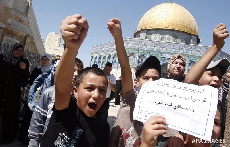 Palestinians shout slogans during a demonstration against the controversial film 'Innocence of Muslims' in front of al-Aqsa Mosqe in Jerusalem, on September 14, 2012. The controversial low budget film reportedly made by...