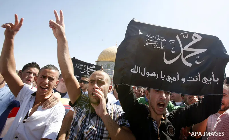 Palestinians shout slogans during a demonstration against the controversial film 'Innocence of Muslims' in front of al-Aqsa Mosqe in Jerusalem, on September 14, 2012. The controversial low budget film reportedly made by...
