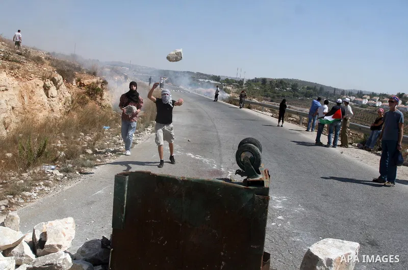 Palestinians make a road barricade during a protest against the confiscation of Palestinian land to expand Jewish settlements in the West Bank village of Nabi Saleh near Ramallah on September 14, 2012.The weekly demonstr...