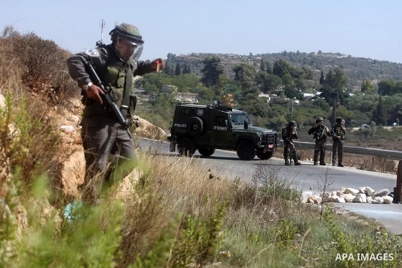Israeli soldiers fire tear gas at Palestinians during a protest against the confiscation of Palestinian land to expand Jewish settlements in the West Bank village of Nabi Saleh near Ramallah on September 14, 2012.The wee...