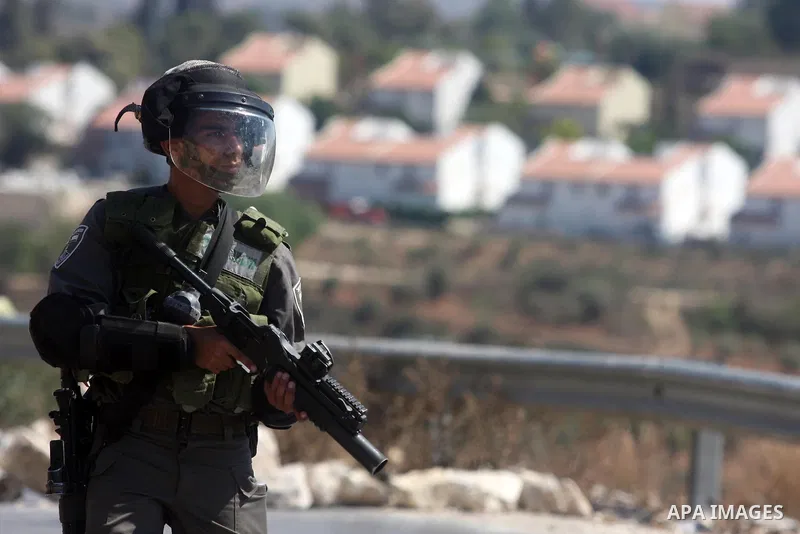 Israeli soldiers fire tear gas at Palestinians during a protest against the confiscation of Palestinian land to expand Jewish settlements in the West Bank village of Nabi Saleh near Ramallah on September 14, 2012.The wee...