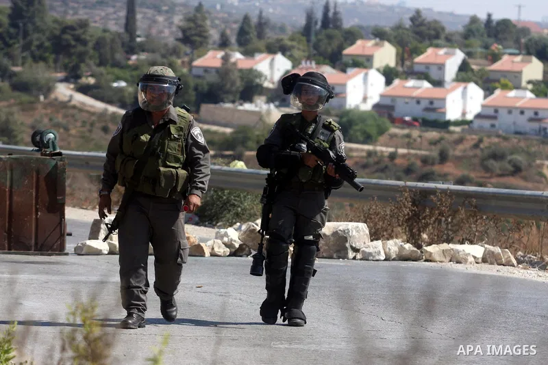 Israeli soldiers fire tear gas at Palestinians during a protest against the confiscation of Palestinian land to expand Jewish settlements in the West Bank village of Nabi Saleh near Ramallah on September 14, 2012.The wee...