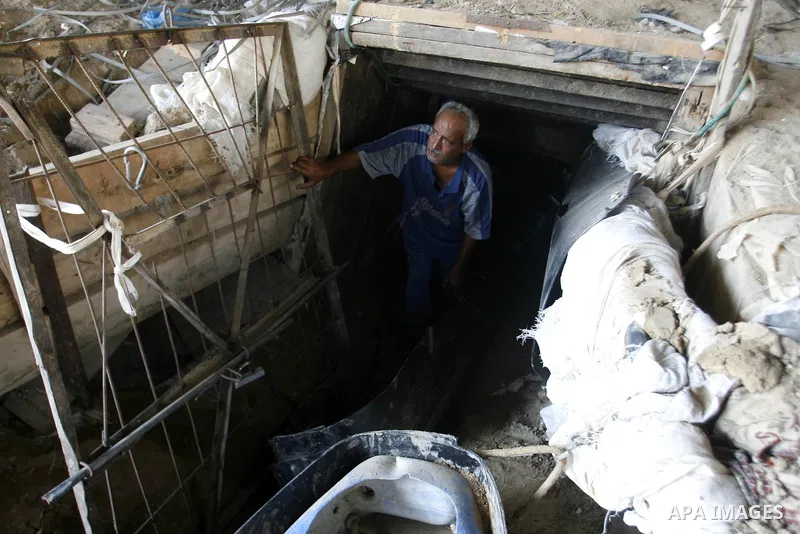 A Palestinian man works inside a tunnel used for smuggling goods, including food, fuel and building materials, along the Gaza-Egypt border in Rafah, in the southern Gaza Strip, on Sept. 15, 2012. The smuggling tunnels un...