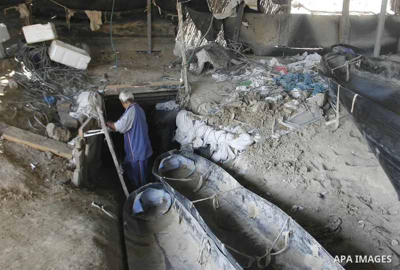 A Palestinian man works inside a tunnel used for smuggling goods, including food, fuel and building materials, along the Gaza-Egypt border in Rafah, in the southern Gaza Strip, on Sept. 15, 2012. The smuggling tunnels un...