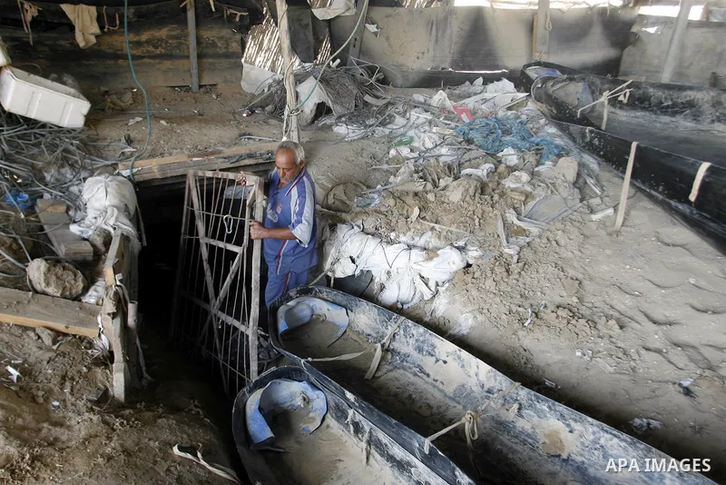A Palestinian man works inside a tunnel used for smuggling goods, including food, fuel and building materials, along the Gaza-Egypt border in Rafah, in the southern Gaza Strip, on Sept. 15, 2012. The smuggling tunnels un...