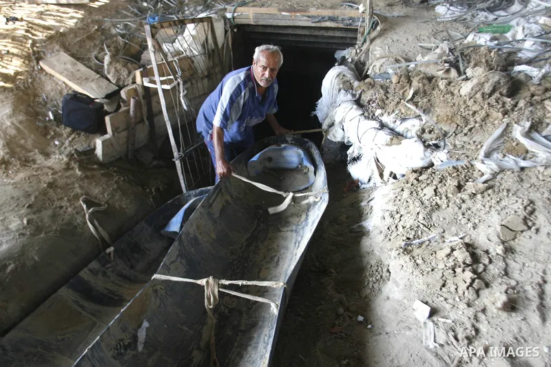 A Palestinian man works inside a tunnel used for smuggling goods, including food, fuel and building materials, along the Gaza-Egypt border in Rafah, in the southern Gaza Strip, on Sept. 15, 2012. The smuggling tunnels un...
