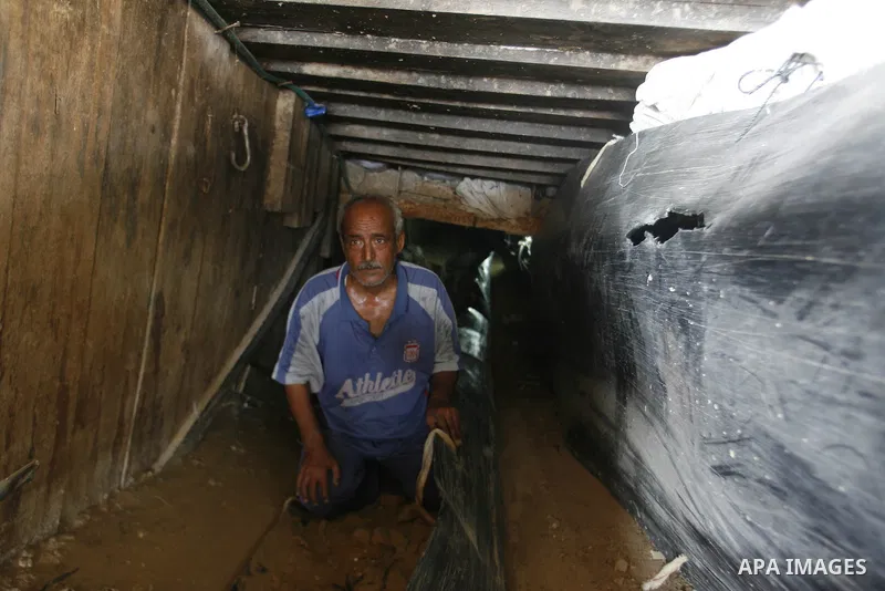 A Palestinian man works inside a tunnel used for smuggling goods, including food, fuel and building materials, along the Gaza-Egypt border in Rafah, in the southern Gaza Strip, on Sept. 15, 2012. The smuggling tunnels un...