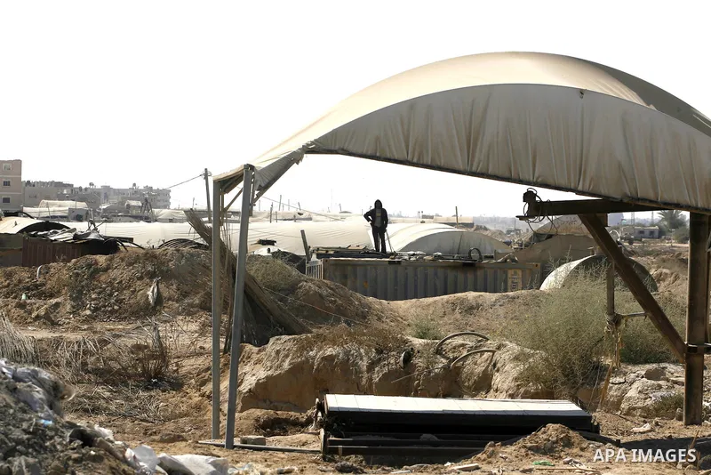 A Palestinian man works outside a tunnel used for smuggling goods, including food, fuel and building materials, along the Gaza-Egypt border in Rafah, in the southern Gaza Strip, on Sept. 15, 2012. The smuggling tunnels u...