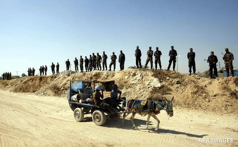 A Palestinian man rides his cart in front of smuggling tunnels along the Gaza-Egypt border in Rafah, in the southern Gaza Strip, on Sept. 15, 2012. The tunnels trade, which analysts estimate is worth half a billion dolla...
