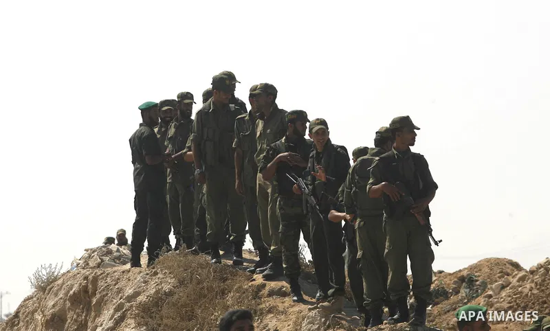 Palestinian border police stand in front of smuggling tunnels on the Gaza-Egypt border in Rafah, in the southern Gaza Strip, on Sept. 15, 2012. The smuggling tunnels under the Gaza-Sinai border serve as conduits for good...