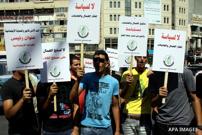 Palestinian protesters shout slogans during a demonstration against the high cost of living in the West Bank city of Nablus, Sept. 15, 2012. The Prime Minister pledged earlier that the Palestinian Authority will decrease...