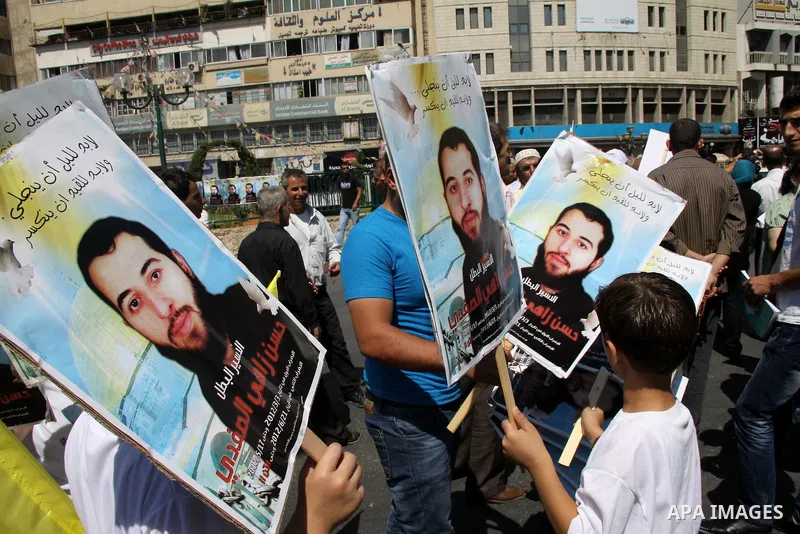 Palestinians take part in a protest calling for release of the Palestinian prisoner in Israeli jails Hasan al-Safadi who is still refusing food since 21 June 2012 , during a demonstration in support him, in the West Bank...
