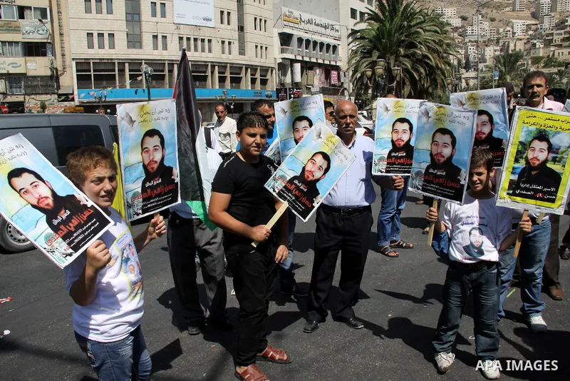 Palestinians take part in a protest calling for release of the Palestinian prisoner in Israeli jails Hasan al-Safadi who is still refusing food since 21 June 2012 , during a demonstration in support him, in the West Bank...