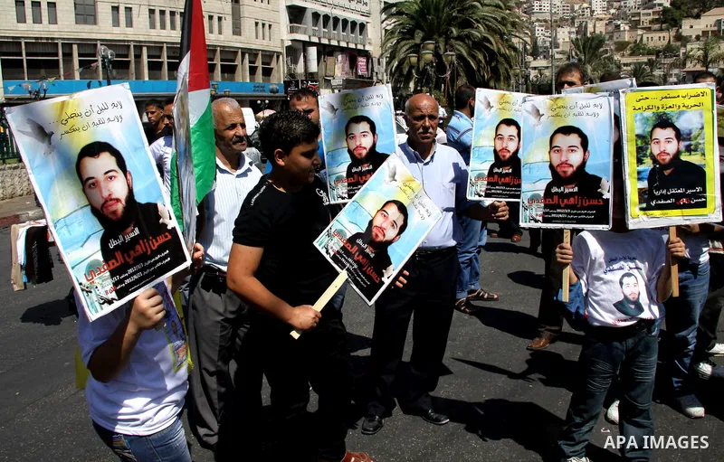 Palestinians take part in a protest calling for release of the Palestinian prisoner in Israeli jails Hasan al-Safadi who is still refusing food since 21 June 2012 , during a demonstration in support him, in the West Bank...