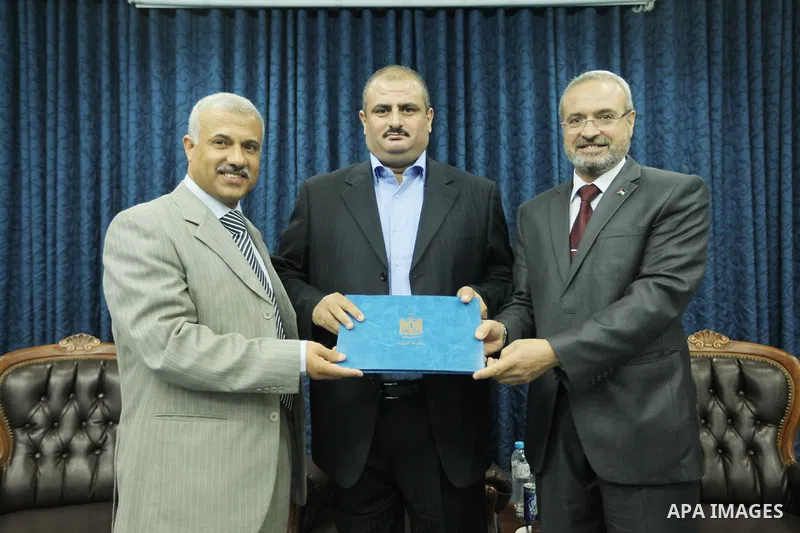 Secretary General of the Palestinian Cabinet in Gaza Strip, Abdel-Salam Siam receives the career duties in Gaza city on Sep. 16, 2012. Photo by Ahmed Shaat