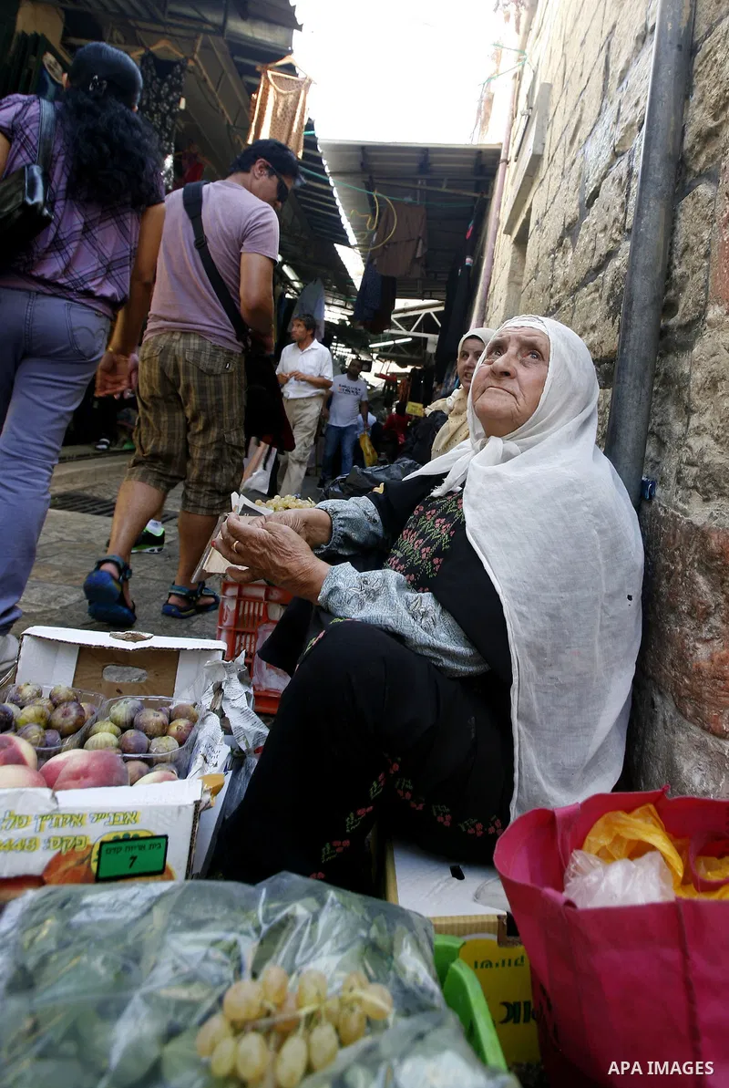 A Palestinian woman sells fruits at the market of Jerusalem's old city on Sept. 16, 2012. Photo by Mahfouz Abu Turk