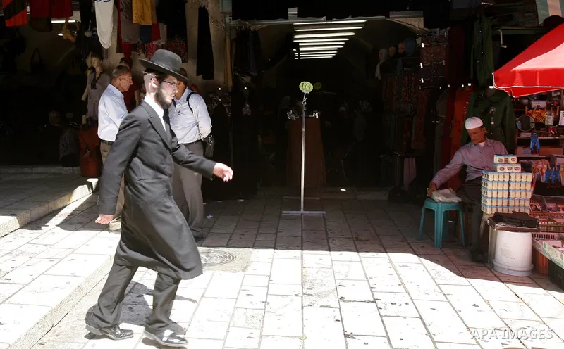An ultra-Orthodox Jewish man walks at the market of Jerusalem's old city on Sept. 16, 2012. Photo by Mahfouz Abu Turk