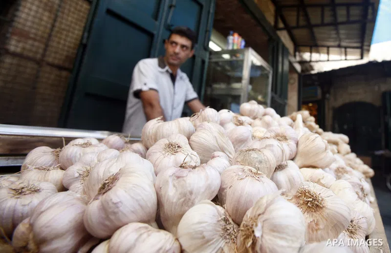 A Palestinian man sells garlic at the market of Jerusalem's old city on Sept. 16, 2012. Photo by Mahfouz Abu Turk
