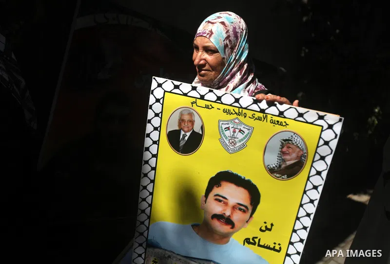 Palestinians hold a placard depicting jailed relatives during a protest in Gaza City calling for the release of Palestinian prisoners from Israeli jails September 17, 2012. Photo by Majdi Fathi