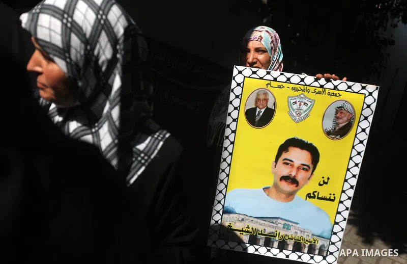 Palestinians hold a placard depicting jailed relatives during a protest in Gaza City calling for the release of Palestinian prisoners from Israeli jails September 17, 2012. Photo by Majdi Fathi