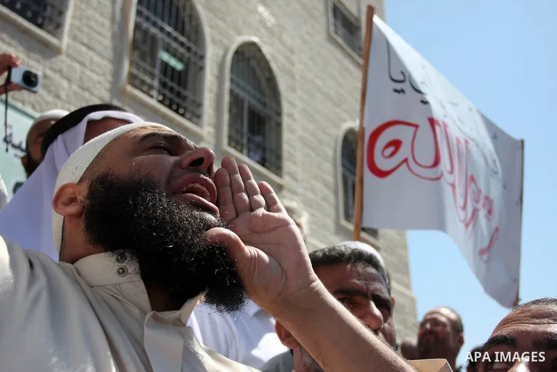 A Palestinian man chants during a peaceful sit-in in the West Bank city of Ramallah on September 17, 2012 against an anti-Islam film that has sparked violent demonstrations in the Muslim world. The low-budget, US-produce...
