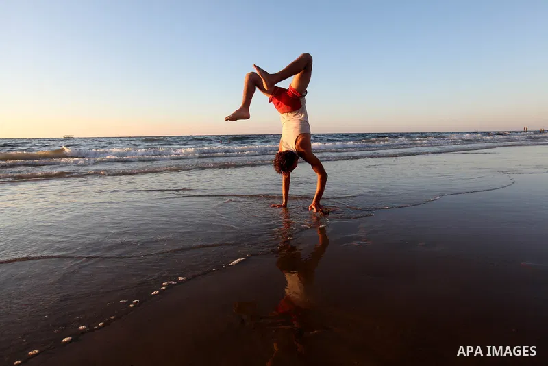 A Palestinian youth plays at the beach of Gaza city, Sept 17, 2012. Photo by Majdi Fathi