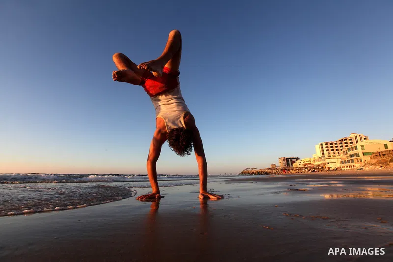 A Palestinian youth plays at the beach of Gaza city, Sept 17, 2012. Photo by Majdi Fathi
