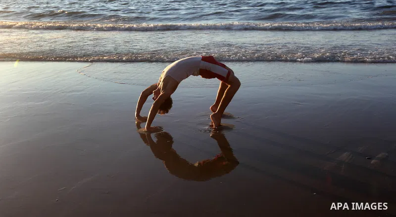 A Palestinian youth plays at the beach of Gaza city, Sept 17, 2012. Photo by Majdi Fathi