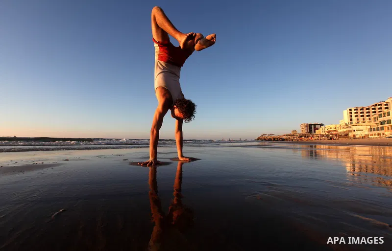 A Palestinian youth plays at the beach of Gaza city, Sept 17, 2012. Photo by Majdi Fathi