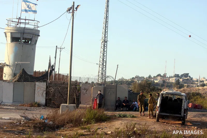 An Israeli soldier detains a Palestinian man on the Atara checkpoint in the West Bank city of Ramallah on September 17, 2012. Photo by Issam Rimawi