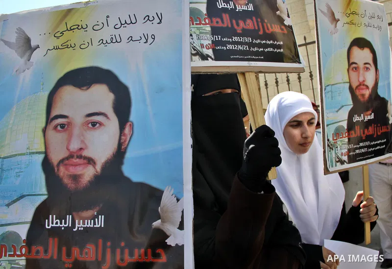 Palestinians participate a protest to calling for the liberty of Palestinians being held in Israeli jails, outside the Red Cross headquarters in the West Bank city of Nablus on September 18, 2012 . Photo by Nedal Eshtaya...