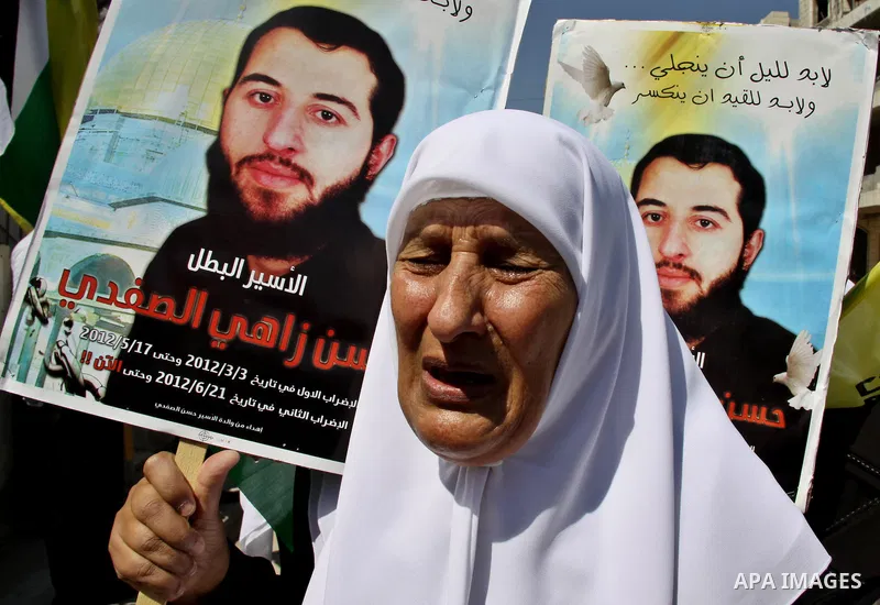 Palestinians participate a protest to calling for the liberty of Palestinians being held in Israeli jails, outside the Red Cross headquarters in the West Bank city of Nablus on September 18, 2012 . Photo by Nedal Eshtaya...