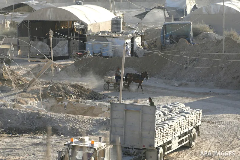 Lorries used to transfer goods from the smuggling tunnels stops working during a protest against the Egyptian decision to close the smuggling tunnels along the Gaza-Egypt border in Rafah, in the southern Gaza Strip, on S...