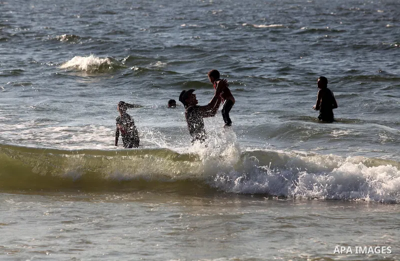 Palestinians enjoy swimming on the beach of Gaza city, Sept. 18, 2012 . Photo by Majdi Fathi