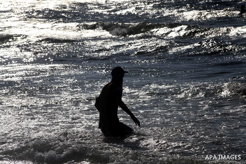 A Palestinian man enjoys swimming on the beach of Gaza city, Sept. 18, 2012 . Photo by Majdi Fathi