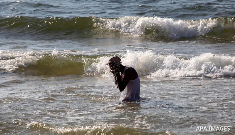 A Palestinian man enjoys swimming on the beach of Gaza city, Sept. 18, 2012 . Photo by Majdi Fathi