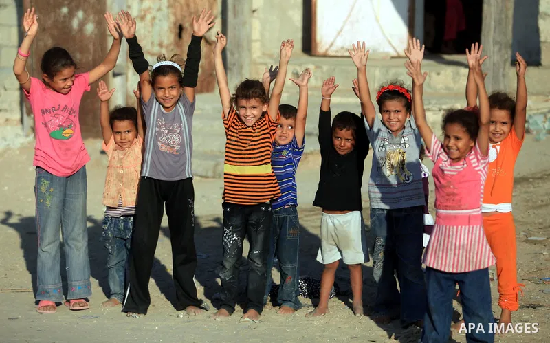 Palestinian children play in front of their house in Deir al-Balah in the central of Gaza strip, Sept. 18, 2012. Photo by Majdi Fathi
