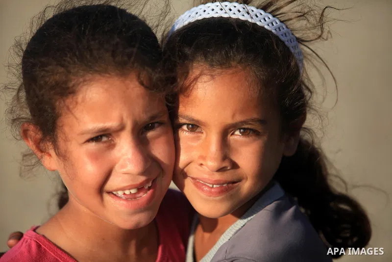 Palestinian girls play in front of their house in Deir al-Balah in the central of Gaza strip, Sept. 18, 2012. Photo by Majdi Fathi