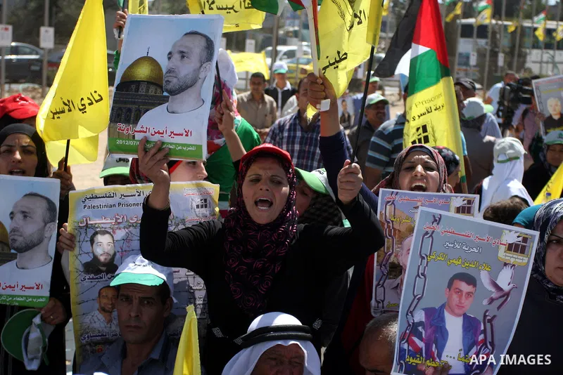 Palestinian women hold portraits of relatives held in Israeli jails during a protest to calling for their liberty, in the West Bank city of Ramallah on September 19, 2012. Photo by Issam Rimawi