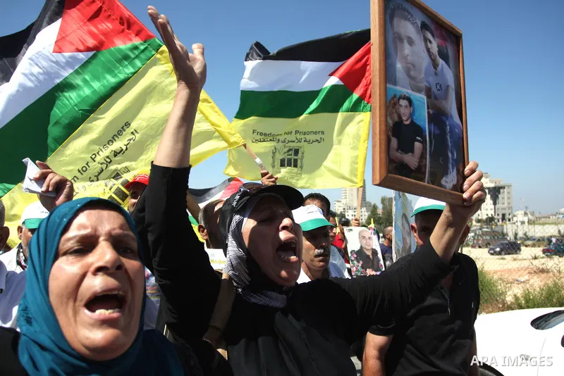 Palestinian women hold portraits of relatives held in Israeli jails during a protest to calling for their liberty, in the West Bank city of Ramallah on September 19, 2012. Photo by Issam Rimawi