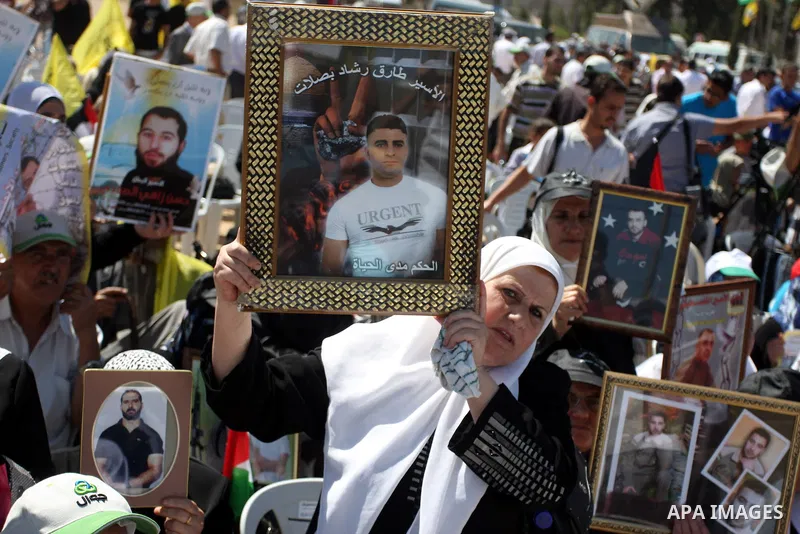 Palestinian women hold portraits of relatives held in Israeli jails during a protest to calling for their liberty, in the West Bank city of Ramallah on September 19, 2012. Photo by Issam Rimawi