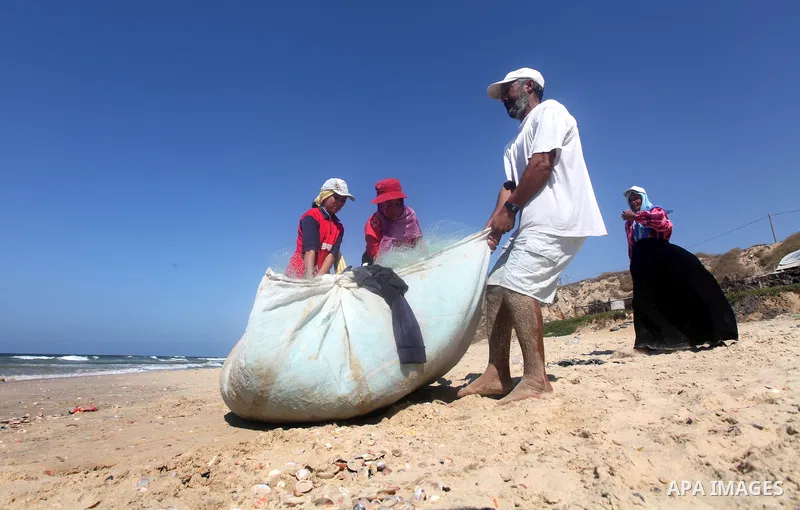 Palestinian fishermen prepare their trawl for fishing at the sea front in Deir al-Balah Palestinian refugee camp, central of Gaza Strip, on September 19, 2012. Photo by Majdi Fathi
