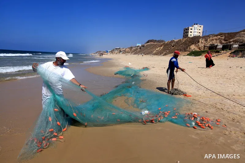 Palestinian fishermen prepare their trawl for fishing at the sea front in Deir al-Balah Palestinian refugee camp, central of Gaza Strip, on September 19, 2012. Photo by Majdi Fathi