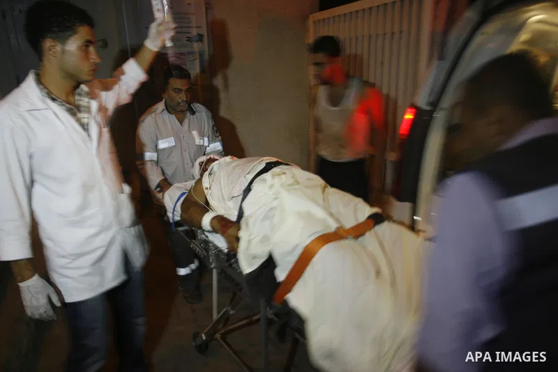 Palestinian medics wheel a wounded person to an ambulance At Al Najar hospital following an Israeli air strike in Rafah southern Gaza Strip, Wednesday, Sept. 19, 2012. A Palestinian health official says an Israeli airstr...