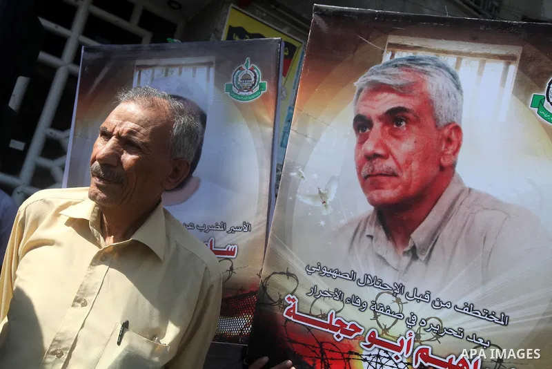 Palestinians hold portraits of relatives held in Israeli jails during a protest to calling for their liberty, in Gaza city on September 20, 2012. Photo by Majdi Fathi