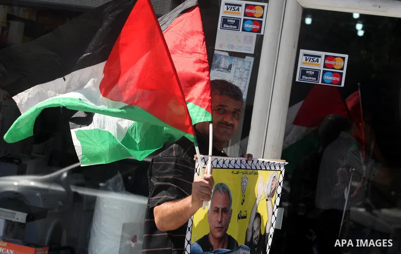 Palestinians hold portraits of relatives held in Israeli jails during a protest to calling for their liberty, in Gaza city on September 20, 2012. Photo by Majdi Fathi