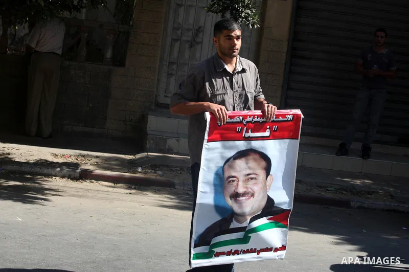 Palestinians hold portraits of relatives held in Israeli jails during a protest to calling for their liberty, in Gaza city on September 20, 2012. Photo by Majdi Fathi