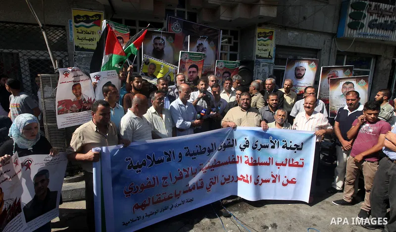 Palestinians hold portraits of relatives held in Israeli jails during a protest to calling for their liberty, in Gaza city on September 20, 2012. Photo by Majdi Fathi