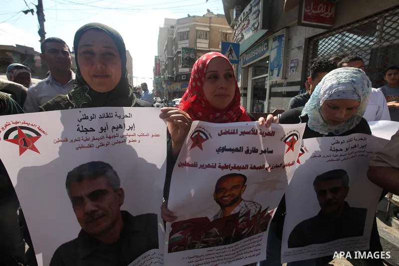 Palestinians hold portraits of relatives held in Israeli jails during a protest to calling for their liberty, in Gaza city on September 20, 2012. Photo by Majdi Fathi